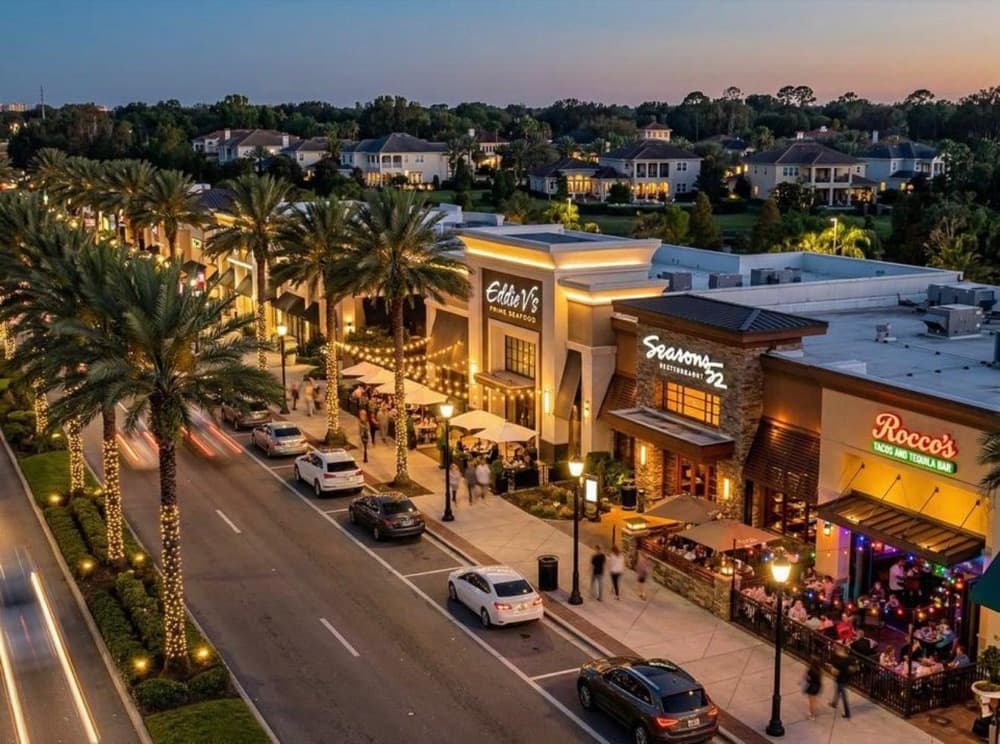 Restaurant Row in Dr. Phillips at dusk, with palm-lined streets and outdoor dining