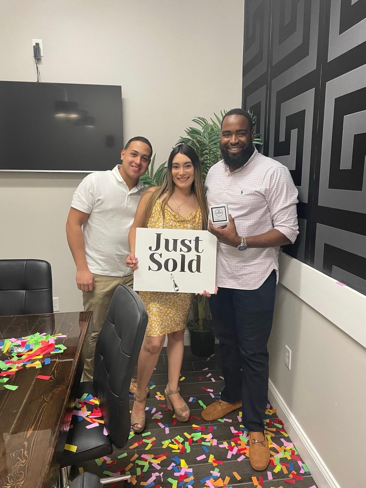 Paul with clients holding a Just Sold sign at closing