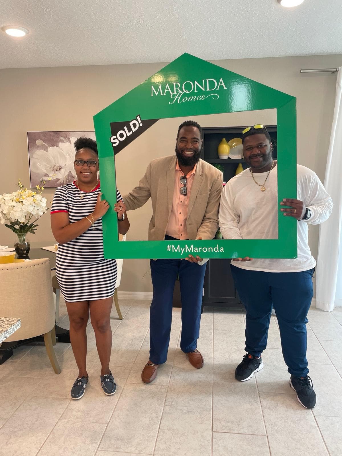 Paul and clients celebrating a sold home in a Maronda Homes frame