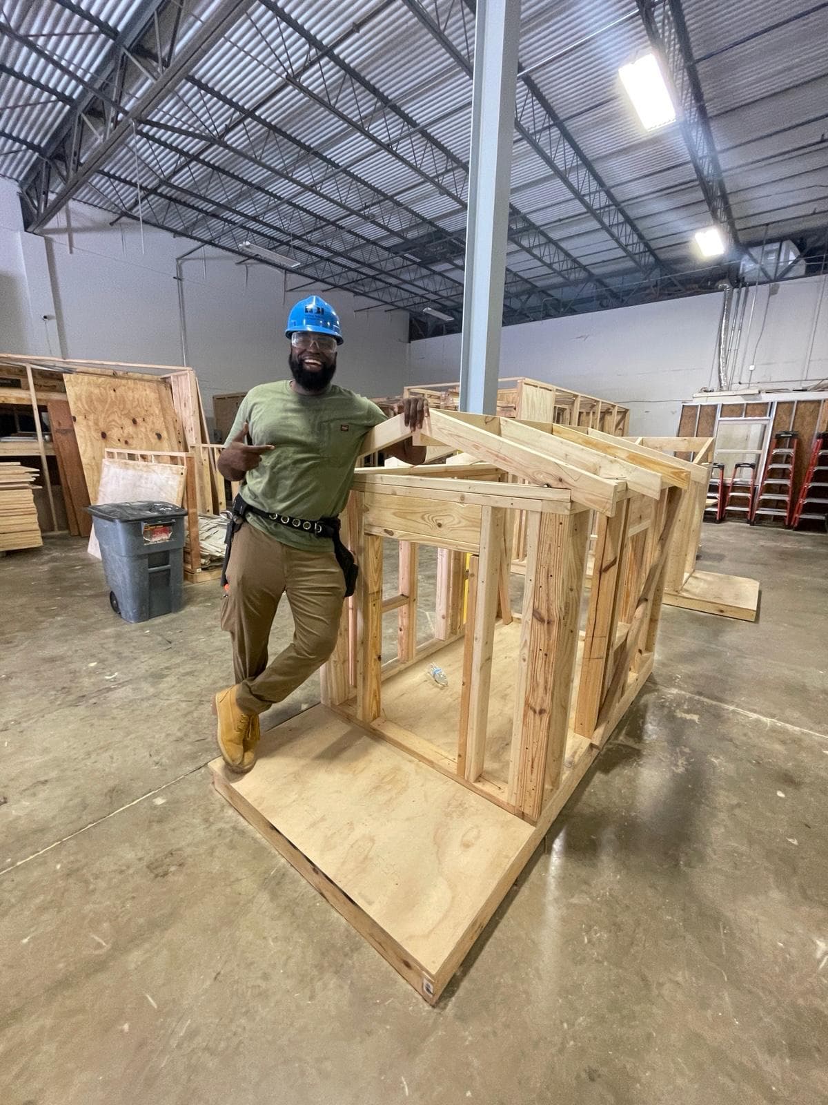 Paul in a hard hat at a new-construction framing site